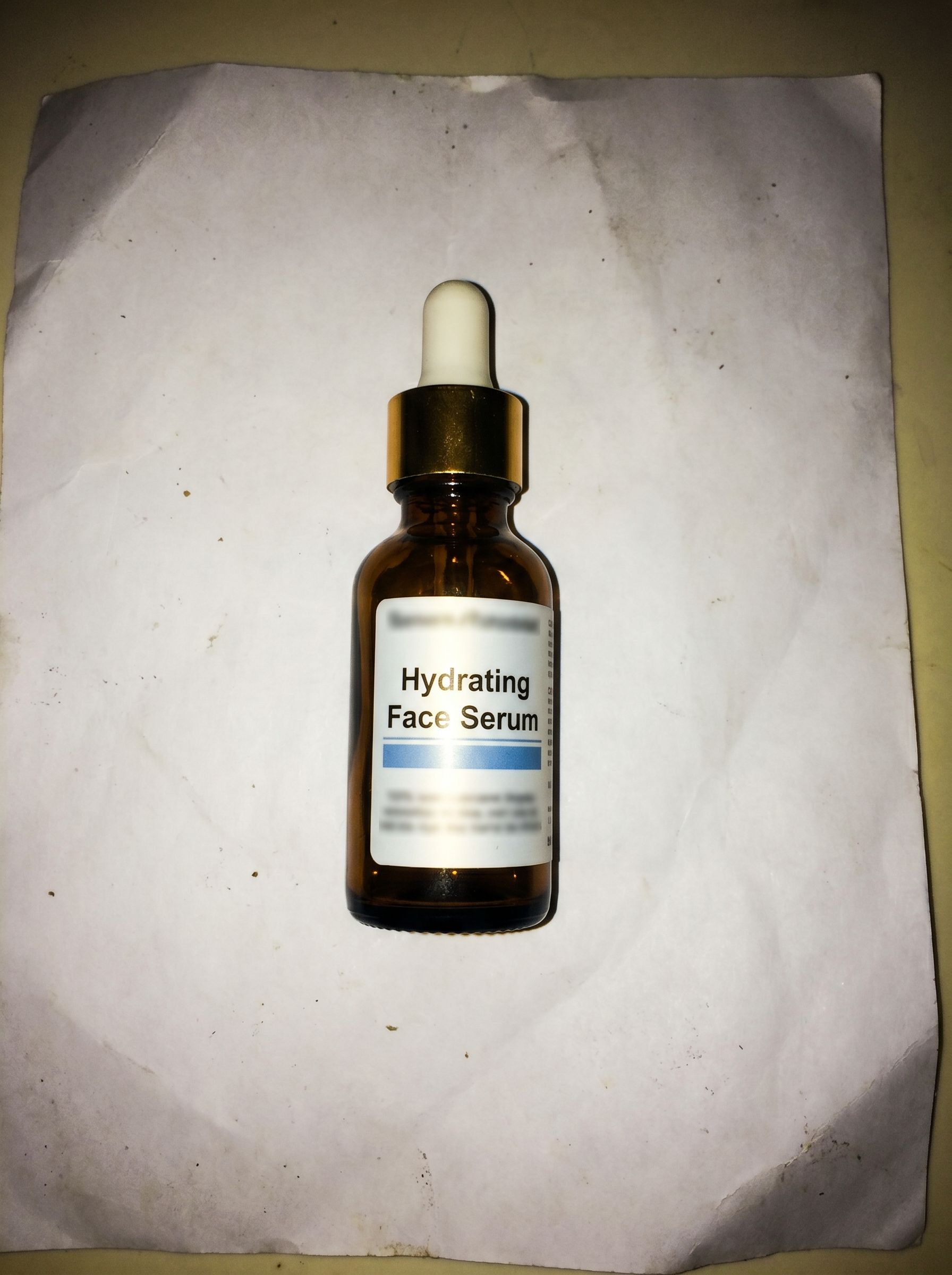 Low-resolution ecommerce product photo before AI upscaling — soft skincare bottle on a white background